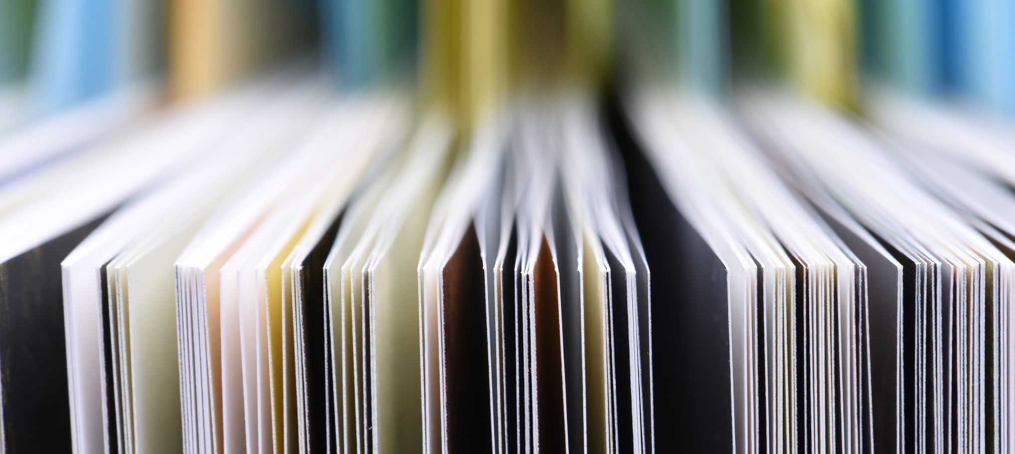 Publication booklets stacked together in an upright position